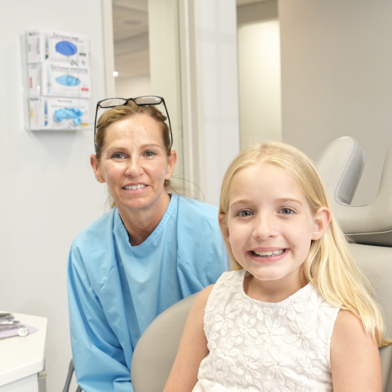 Orthodontist Dr. Jessica Bowen with young patient smiling in dental chair at Bowen Family Orthodontics, showcasing friendly, welcoming atmosphere for new patients in Woolwich, Sewell, and surrounding areas.