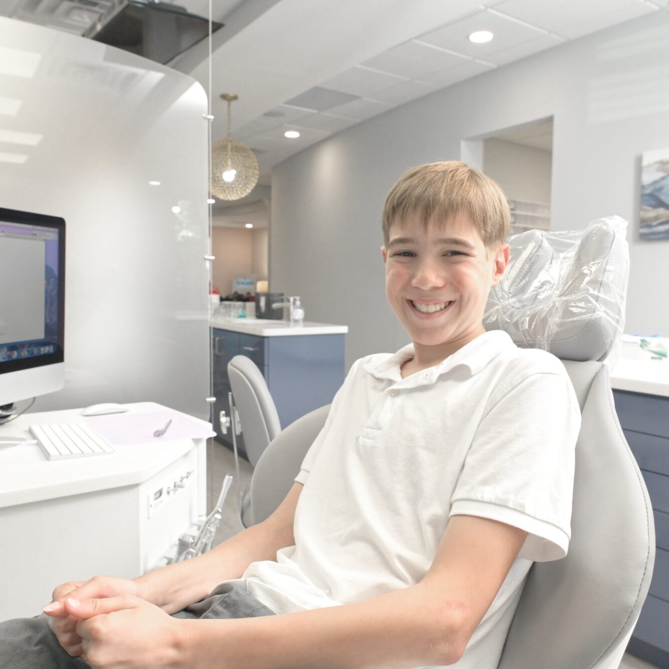 Smiling young patient in orthodontic chair at Bowen Family Orthodontics, showcasing welcoming atmosphere in Mullica Hill, NJ.