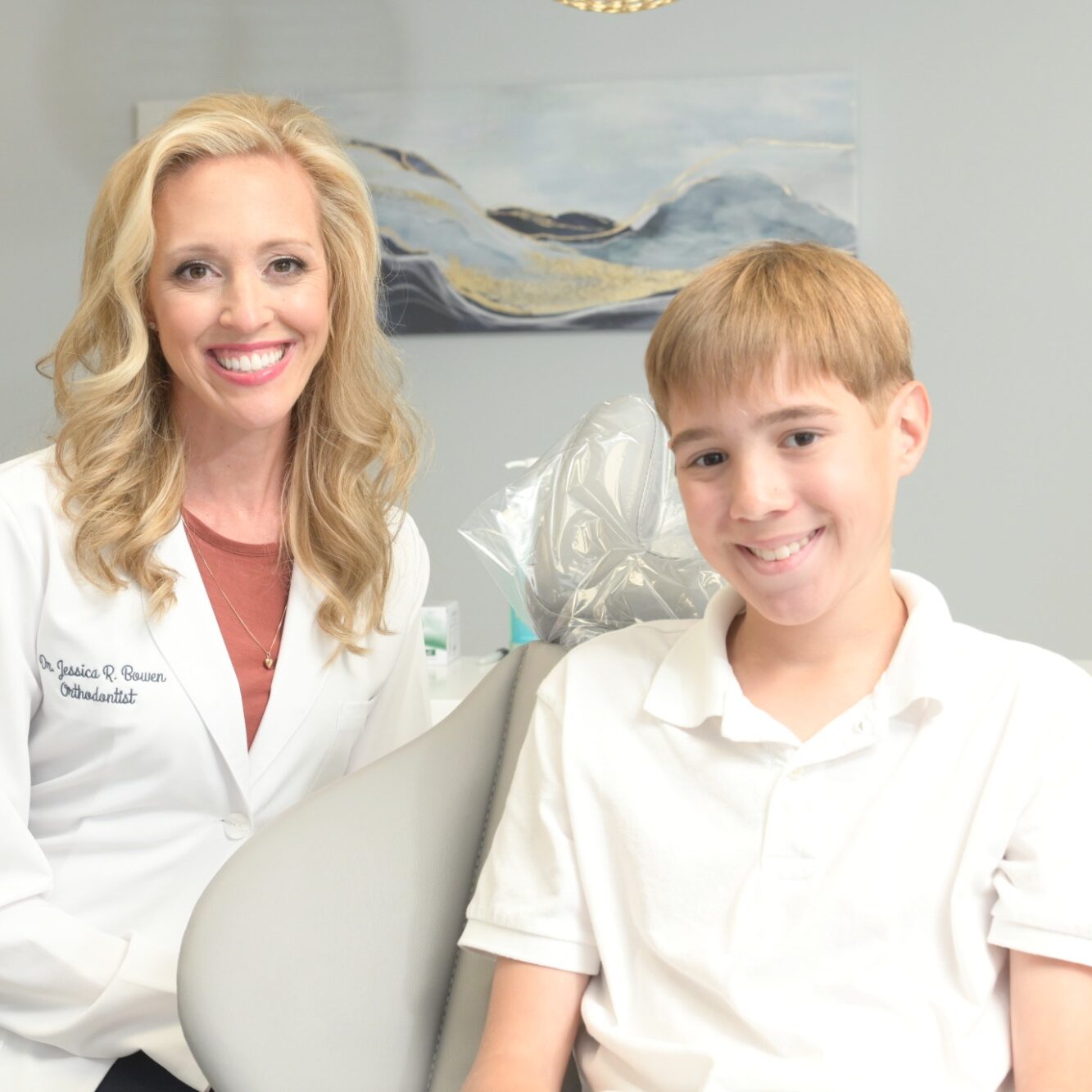 Dr. Jessica Bowen smiling with a young patient in an orthodontic office, highlighting personalized care at Bowen Family Orthodontics in Mullica Hill.