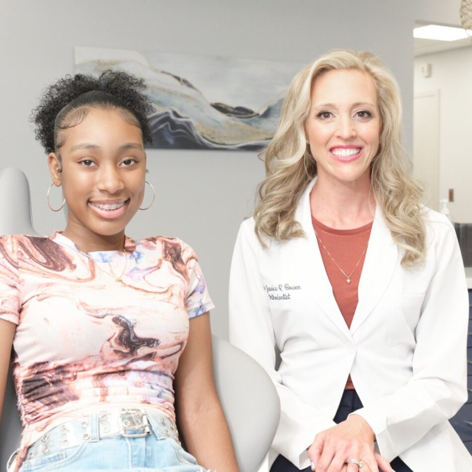 Smiling teen girl with braces seated next to Dr. Jessica Bowen, orthodontist at Bowen Family Orthodontics, in a modern clinic setting.